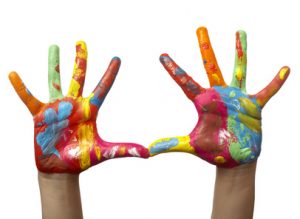 close up of child  hands painted with watercolors, on white background with clipping path